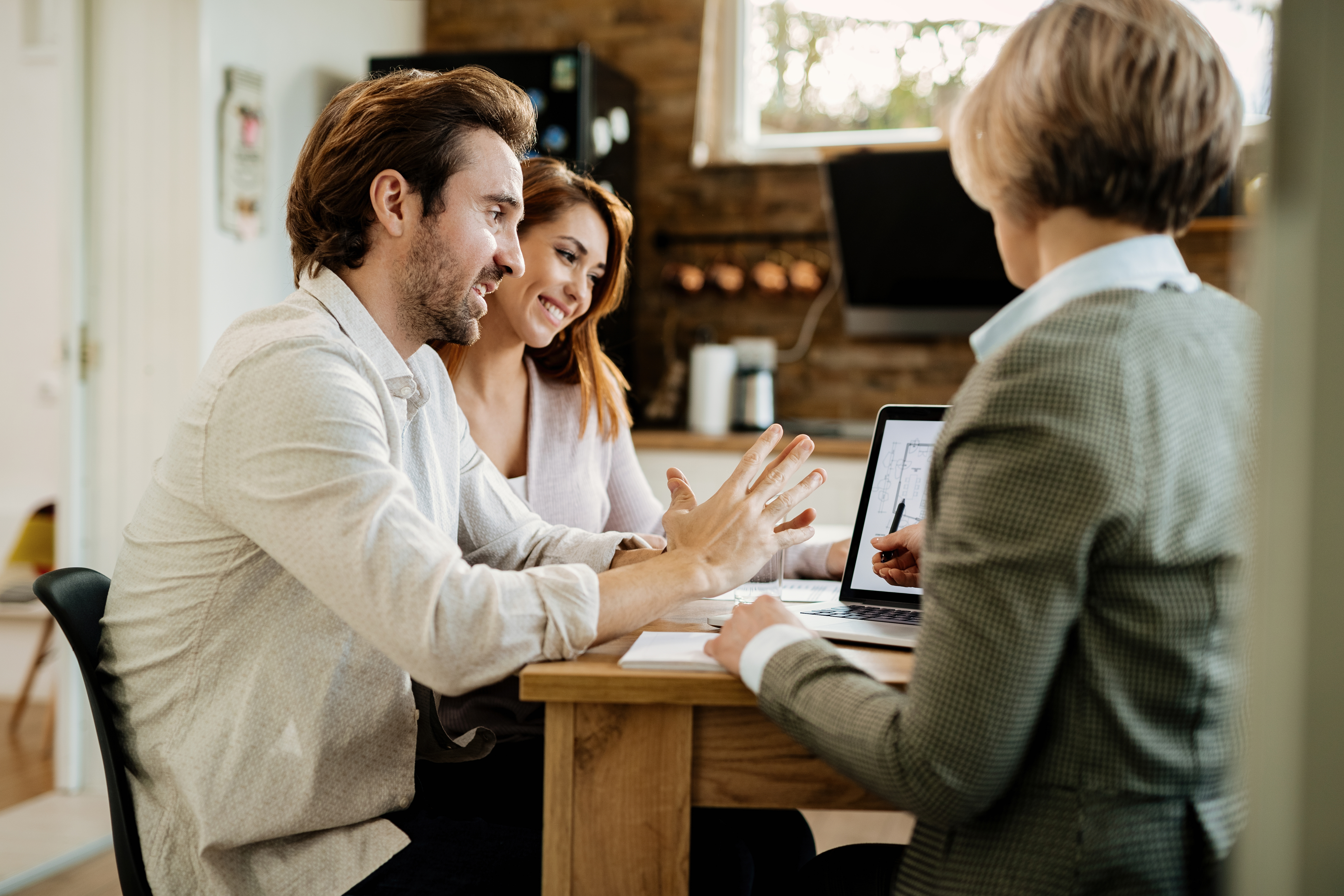 Obrázek young-happy-couple-their-real-estate-agent-using-laptop-while-having-meeting-their-home.jpg